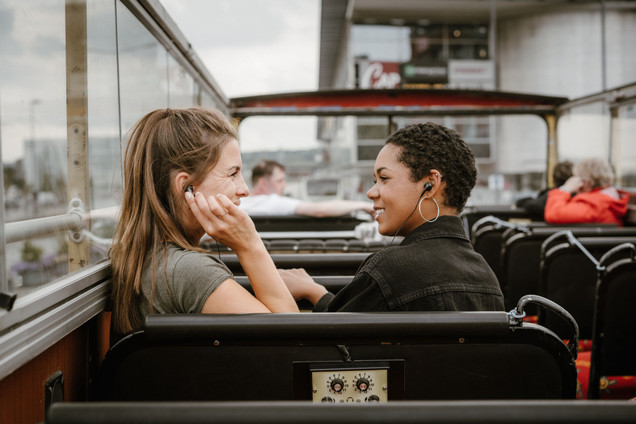 Two women on a bus of a hop on hop off city tour 