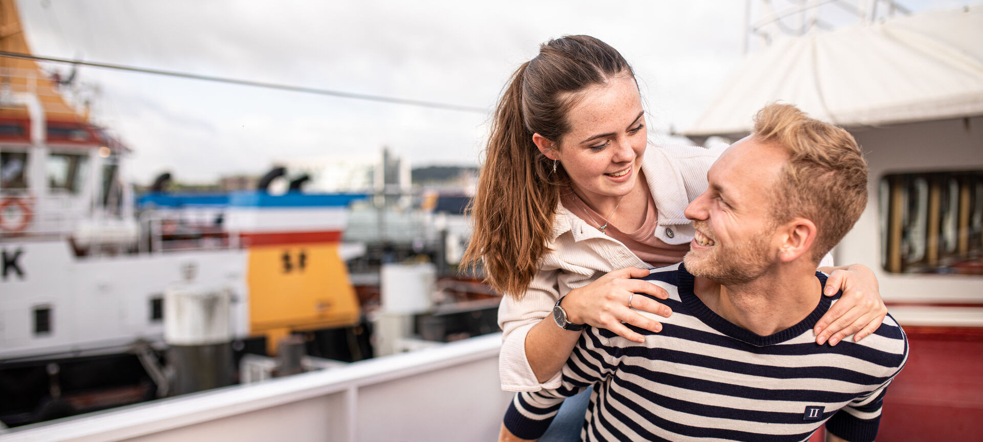 a couple enjoying a harbour tour on a ship